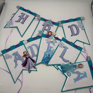 May include: A white ceramic mug with a black handle and the text "But First, Coffee" in a black, handwritten-style font. The mug is on a white surface.