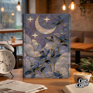 May include: A rectangular tablet case featuring a stained glass design with a crescent moon, four-pointed stars, and blue roses. The artwork is composed of purple and blue marbled segments outlined in gold, creating a mosaic effect across the surface.