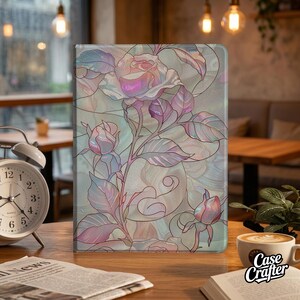 Könnte beinhalten: Eine rechteckige Tablethülle mit einer Illustration von Rosen im Buntglas-Stil in schillernden Rosa-, Violett- und sanften Blautönen. Das Design zeigt detaillierte Umrisse von Rosenblüten, Knospen und Blättern vor einem schimmernden Hintergrund.