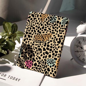 May include: A white ceramic mug with a black handle and the text "But First, Coffee" in a handwritten style. The mug is on a white surface. The mug is approximately 4 inches tall.