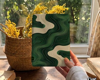 May include: A rectangular e-reader cover featuring a topographic map pattern with flowing, layered lines in shades of deep forest green, emerald, and cream. The design creates a fluid, abstract landscape effect across the entire surface.