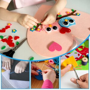 May include: A craft project featuring a large light pink felt heart, a brown felt tree branch, and two felt owls in blue and pink with large googly eyes. The scene includes loose red heart-shaped felt pieces, small blue and pink flowers, and scissors.