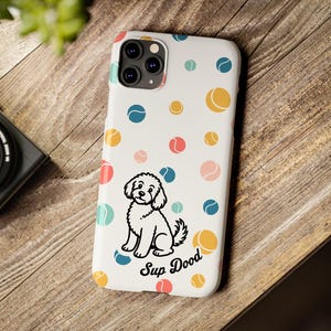 May include: A white smartphone case featuring a repeating pattern of small, multicolored circles resembling tennis balls. A black and white line drawing of a curly-haired dog sits near the bottom, accompanied by the black text Sup Dood.