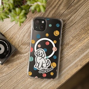 May include: A clear smartphone case featuring a black background with a repeating pattern of small, multi-colored tennis balls in yellow, blue, and red. A white circular ring is centered, with a white illustration of a dog and the text Sup Dood.