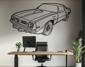 May include: A black metal wall art piece shaped like the outline of a classic muscle car. The design features the front and side profile of the vehicle, including the hood scoop, headlights, and wheels, mounted on a plain white wall surface.