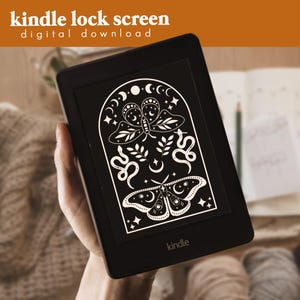 May include: A black and white digital illustration of a moth, snakes, and crescent moons in an archway design. The image is displayed on a Kindle e-reader screen. The text "kindle" is visible at the bottom of the screen.