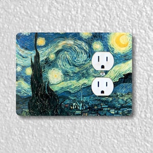 May include: A decorative outlet cover featuring a reproduction of Vincent van Gogh's "Starry Night" painting. The cover is white with two standard electrical outlets.