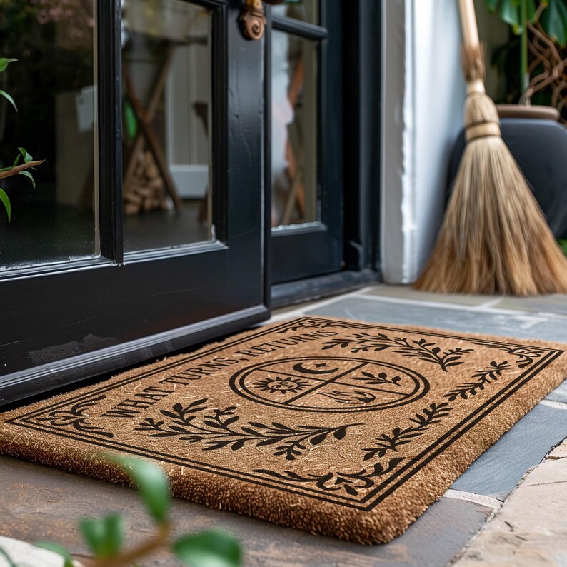 Natural coir doormat featuring "What Turns, Returns" text with sacred elemental symbolism including sun, crescent moon, flames, and botanical sprigs arranged in protective circular mandala design. Four classical elements represented in quadrants surrounded by intricate corner flourishes and leafy botanical borders. Perfect witchy welcome mat for pagan home decor, spiritual protection, and mystical entryway styling.