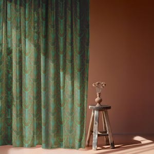 Sheer curtain panel featuring an intricate pattern of luminous emerald green Luna moths on an amber background. The design shows symmetrical rows of moths with delicate wing details and botanical elements in a vertical arrangement.