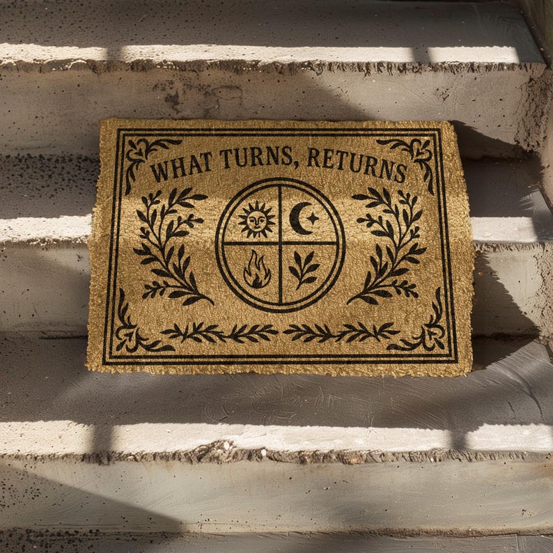 Natural coir doormat featuring "What Turns, Returns" text with sacred elemental symbolism including sun, crescent moon, flames, and botanical sprigs arranged in protective circular mandala design. Four classical elements represented in quadrants surrounded by intricate corner flourishes and leafy botanical borders. Perfect witchy welcome mat for pagan home decor, spiritual protection, and mystical entryway styling.
