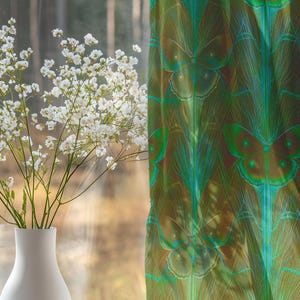 Sheer curtain panel featuring an intricate pattern of luminous emerald green Luna moths on an amber background. The design shows symmetrical rows of moths with delicate wing details and botanical elements in a vertical arrangement.