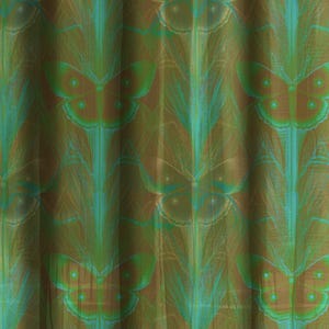 Sheer curtain panel featuring an intricate pattern of luminous emerald green Luna moths on an amber background. The design shows symmetrical rows of moths with delicate wing details and botanical elements in a vertical arrangement.