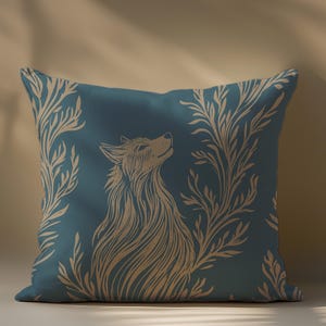 May include: A teal blue throw pillow with a beige wolf and floral design. The wolf is facing to the right and looking up. The floral design is on both sides of the wolf.