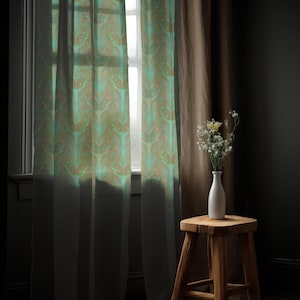 Sheer curtain panel featuring an intricate pattern of luminous emerald green Luna moths on an amber background. The design shows symmetrical rows of moths with delicate wing details and botanical elements in a vertical arrangement.