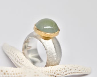 Silver, 18k yellow gold, aquamarine cabochon