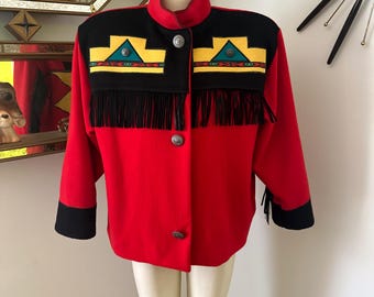 May include: A red wool jacket with black trim and fringe. The jacket has a geometric pattern on the shoulders in yellow, green, and black.