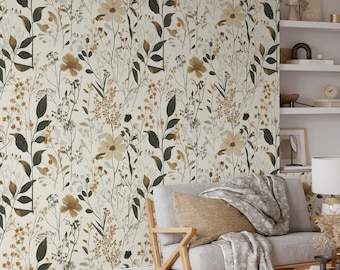 Puede incluir: Un papel tapiz beige con un patrón floral que presenta hojas y flores marrones y verdes. El papel tapiz se muestra en un ambiente de sala de estar con un sofá y una mesa auxiliar.