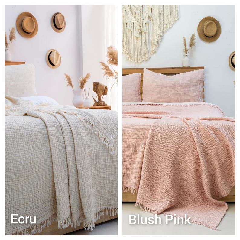 May include: Two beds featuring textured, crinkled cotton muslin blankets with fringe edges. One bed is covered in an ecru-colored blanket, while the other bed is covered in a blush pink-colored blanket. Both blankets have a soft, layered appearance.