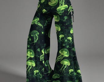 Puede incluir: Pantalones de pierna ancha con base negra y un patrón repetitivo de medusas de color verde neón brillante. Los pantalones tienen un diseño de cintura alta con una pretina ancha doblada y un detalle de cordón en el lado derecho de la cadera.