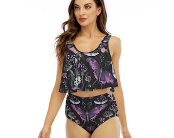 May include: A two-piece swimsuit featuring a black base with a repeating pattern of purple butterflies and various mushrooms in shades of pink, white, and grey. The top is a sleeveless crop tank style, and the bottoms are high-waisted briefs.
