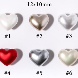 May include: Six heart-shaped beads in various colors: white, gold, silver, red, and pearlescent. Each bead is approximately 0.47 x 0.39 inches, with numbers #1 through #6 below each bead. The beads have a glossy finish.