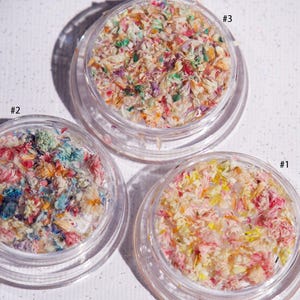 May include: Three small jars of colorful dried flower petals, labeled #1, #2, and #3.