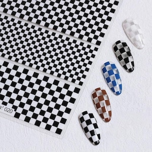 May include: Nail art stickers with a black and white checkerboard pattern. Several nail designs are shown with the same pattern in black and white, brown and white, and blue and white. The stickers are on a white background.