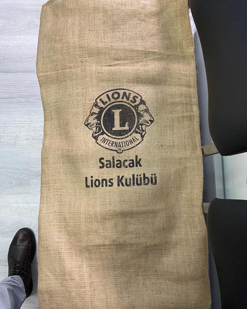 May include: A brown burlap sack with the Lions International logo and the text "Salacak Lions Kul&uuml;b&uuml;".