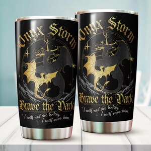 May include: Two black and gold stainless steel tumblers with a dragon design and the text "Onyx Storm Brave the Dark I will not die today. I will save him."