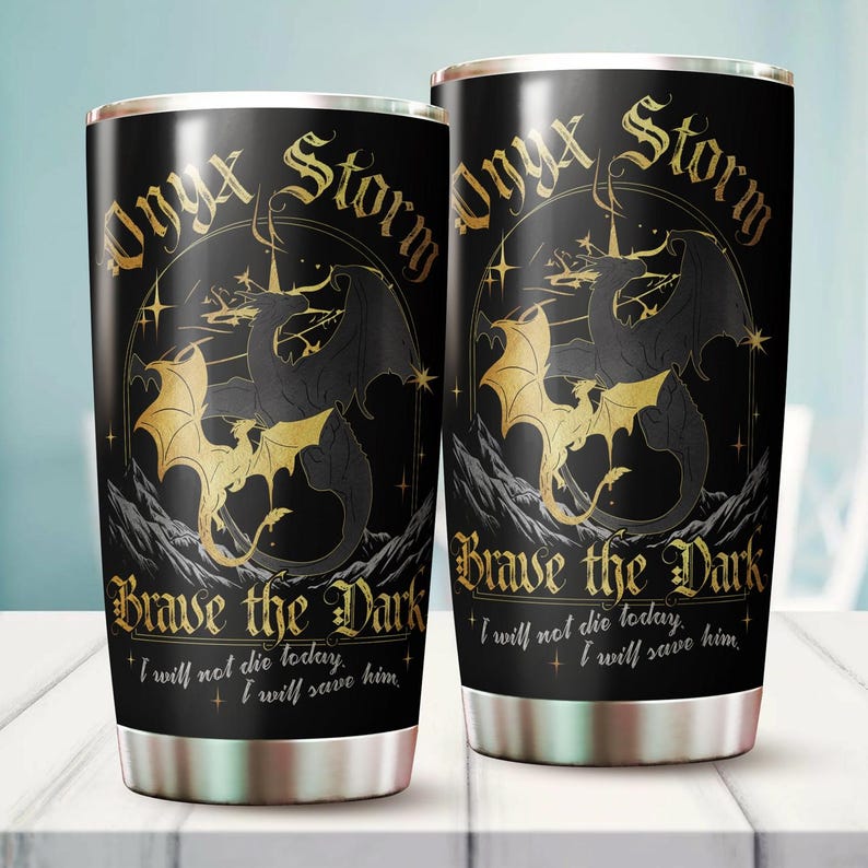 May include: Two black and gold stainless steel tumblers with a dragon design and the text "Onyx Storm Brave the Dark I will not die today. I will save him."