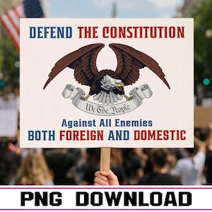 May include: A sign held aloft in a crowd, bearing the words "DEFEND THE CONSTITUTION" in red and blue. An eagle graphic is above the words "Against All Enemies BOTH FOREIGN AND DOMESTIC". The words "We The People" are on a banner.