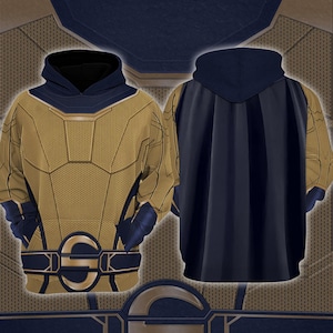 May include: A hooded sweatshirt with a superhero-inspired design. The front features a gold and navy blue color scheme with a geometric pattern. The back of the hoodie is navy blue with a cape-like design. The design includes a belt with a gold emblem.