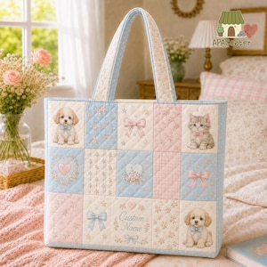 May include: A quilted tote bag featuring a patchwork design of light blue and pink squares. The pattern includes illustrations of puppies, a kitten, bows, hearts, and floral motifs. The centre panel contains the text Custom Name.