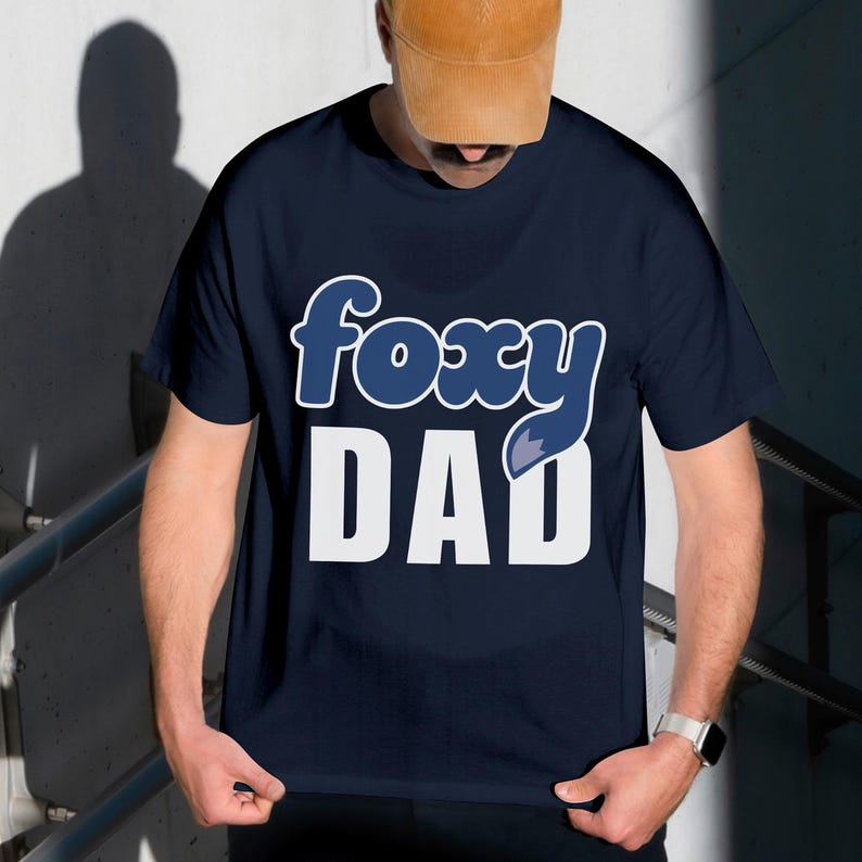 A man wearing a blue t-shirt with the text "FOXY DAD" printed on it.