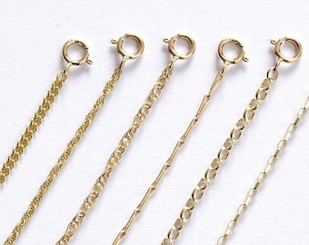 May include: Seven gold chain extenders of varying lengths and styles. The chains are all made of a fine gold material and have a delicate, feminine look.