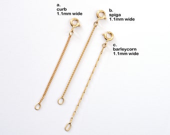 May include: Three gold chains, each with a different style: curb, spiga, and barleycorn. Each chain is 1.1 mm wide.