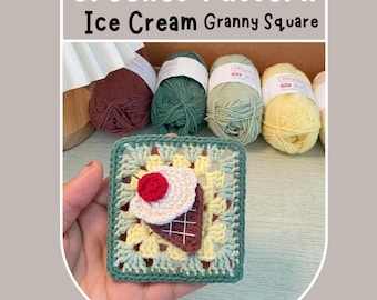 May include: A crocheted granny square with a green, yellow, and white color scheme. The square features a crocheted ice cream cone with a brown waffle cone, white ice cream, and a red cherry on top.