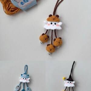 May include: Three handmade crochet ornaments. One features a white ghost-like figure with a brown bear hat and bear-shaped dangling accents. Another has a blue hat and fish accents. The third has a black witch hat and yellow accents.