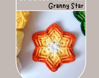 May include: A crocheted star-shaped granny square in shades of orange, yellow, and white. The center of the star features a smaller white flower.