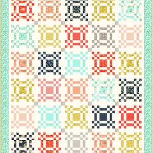 May include: A quilt pattern featuring a variety of colourful squares. The squares are arranged in a grid pattern and feature different floral and geometric designs. The quilt is bordered with a light blue and green floral pattern.