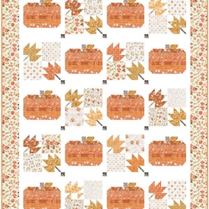 May include: A rectangular quilt featuring a repeating pattern of orange pumpkins and golden maple leaves on a white background. The quilt is framed by a border decorated with small orange flowers and green leaves, creating a cohesive autumn-themed design.