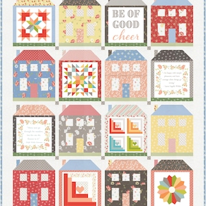 May include: A quilt with a patchwork design of houses. Each house has a different pattern and color. The quilt has a white background and the houses are arranged in a grid pattern. The quilt includes the text "Be of good cheer".