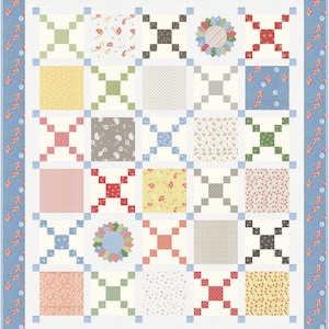 May include: A quilt block pattern with a variety of floral and geometric prints in shades of red, blue, green, yellow, and white. The quilt blocks are arranged in a grid pattern and are surrounded by a blue and white border.