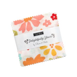 May include: A stack of fabric squares with a floral pattern in shades of orange, pink, and yellow. The fabric is wrapped with a white band that reads "Delightfully Yours" by Sherri & Chelsi.