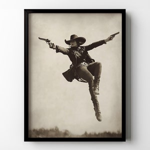 May include: A sepia-toned photograph of a person wearing a cowboy hat and a long coat, jumping in the air while holding two pistols. The person is wearing jeans and boots.