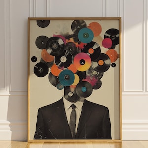 May include: A framed art print featuring a man in a suit with a head composed of colorful vinyl records. The records are in various colors, including black, orange, pink, and blue, creating a unique and artistic design.
