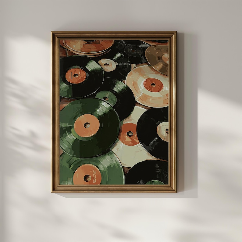 May include: A framed print depicting a collection of vinyl records. The records have orange and white labels, with shades of green, black, and tan. The artwork is in a gold frame, creating a vintage aesthetic.