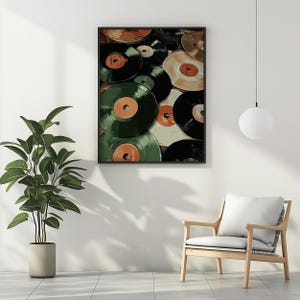 May include: A framed print showcasing a collection of vintage vinyl records. The records are in various colors, including black, green, and tan, with orange and tan labels. The artwork is displayed on a white wall, with a plant and chair in the foreground.