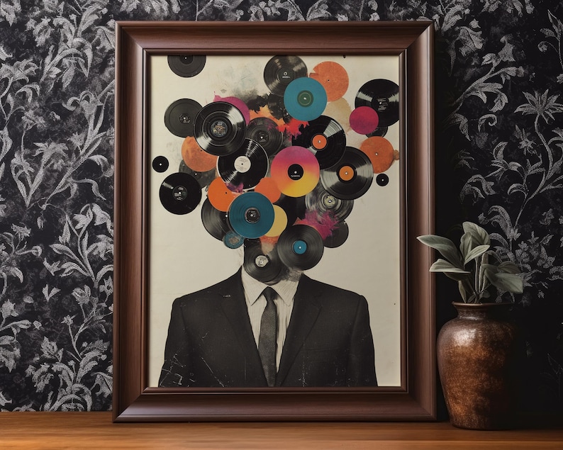 May include: Framed art print featuring a man in a suit with a head composed of colorful vinyl records. The records are in various colors, including orange, pink, and blue. The frame is a dark brown color, and the background is a neutral tone.