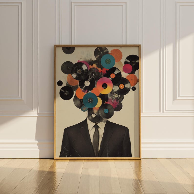 May include: A framed art print featuring a man in a suit with a head composed of colorful vinyl records. The records are in various colors, including black, orange, pink, and blue, creating a unique and artistic design.